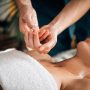 Ayurvedic aromatherapy oil massage. Masseuse holding Ayurveda oil for body massage