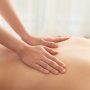 Hands of woman massaging back of female client