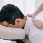 close-up shot of masseuse doing seated back massage for businessman